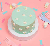 Mini Filled Sponge Cake With Daisies In Green On A Pink Background